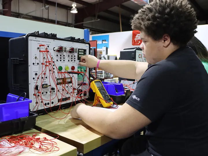 Student in classroom on equipment.